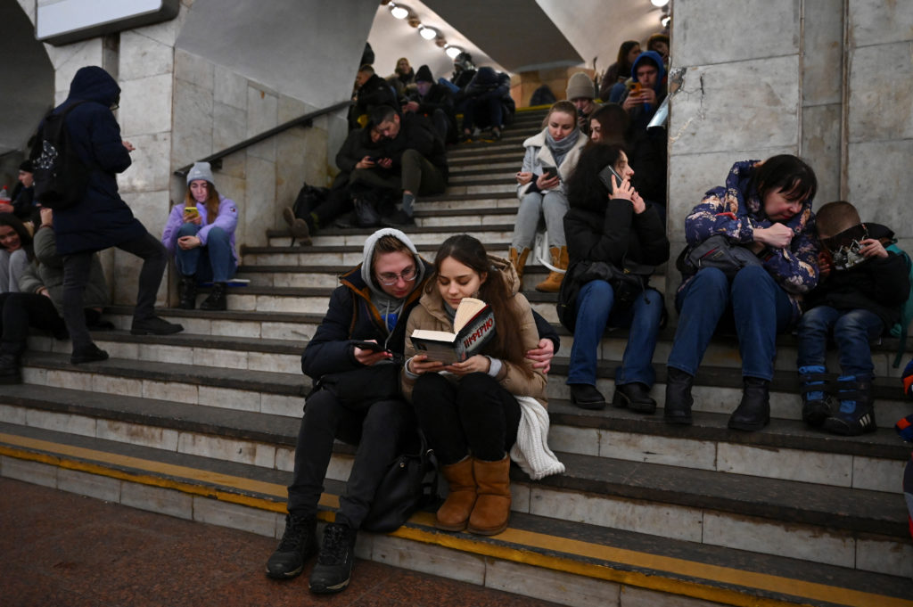 People take shelter inside a metro station during massive Russian missile attacks in Kyiv