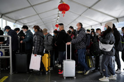 People walk with their luggage at a railway station during the annual Spring Festival travel rush ahead of the Chinese Lunar New Year, as the coronavirus disease (COVID-19) outbreak continues, in Shanghai, China January 16, 2023. Photo by Aly Song/REUTERS