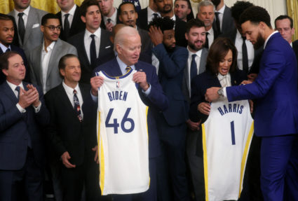 U.S. President Joe Biden and Vice President Kamala Harris receive jerseys from basketball player Stephen Curry on behalf of his team during an event in the East Room hosted by President Biden and Vice President Harris to honor the Golden State Warriors for their 2022 NBA championship at the White House in Washington, U.S., January 17, 2023. Photo by Leah Millis/REUTERS