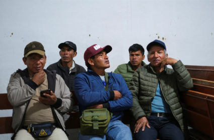 People rest before heading to Lima to gather with protesters for the 'Capture of Lima' march