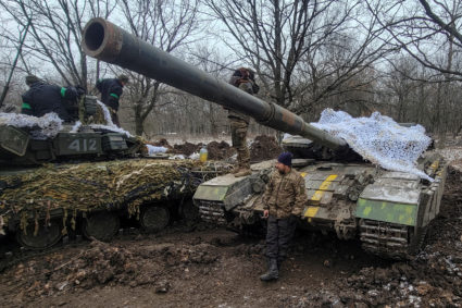 FILE PHOTO: Ukrainian servicemen stand n on their tanks near the frontline town of Bakhmut
