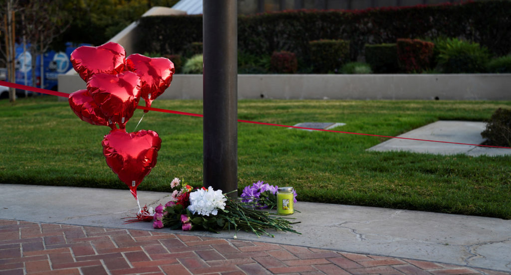 Flowers and heart balloons are left near the scene of a shooting that took place during a Chinese Lunar New Year celebrati...
