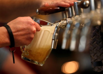 A bartender pours a glass of beer in Prague