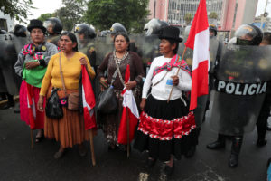 Anti-government protesters take part in a march in Lima