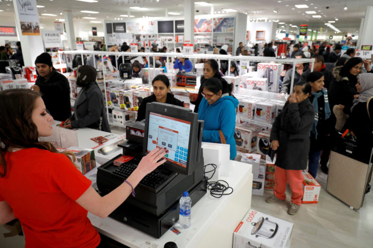 Customers pay for their purchases during the Black Friday sales event on Thanksgiving Day at JCPenney in Niles