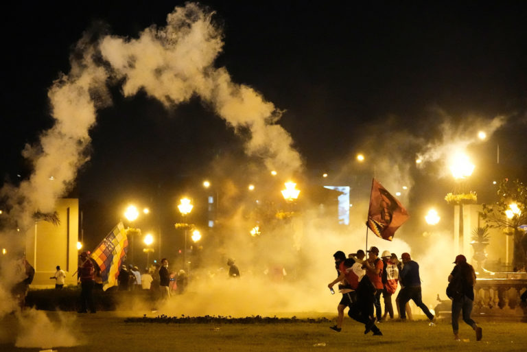 Anti-government protesters take part in a march in Lima