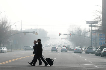 Men cross the street in smog filled downtown Salt Lake City