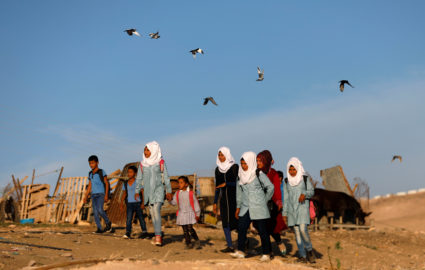 Palestinian students make their way to school in the Palestinian Bedouin village of Khan al-Ahmar that Israel plans to demolish, in the occupied West Bank October 16, 2018. Photo by Mohamad Torokman/REUTERS