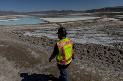 An employee walks near lithium evaporation ponds at Albemarle Lithium production facility in Silver Peak, Nevada, U.S. October 6, 2022. Photo by Carlos Barria/REUTERS