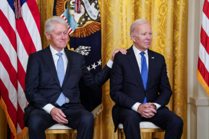 Former U.S. President Bill Clinton sits with U.S. President Joe Biden during an event to mark the 30th anniversary (Feb. 5, 1993) of the Family and Medical Leave Act, in the East Room at the White House in Washington, U.S., February 2, 2023. Photo by Kevin Lamarque/REUTERS