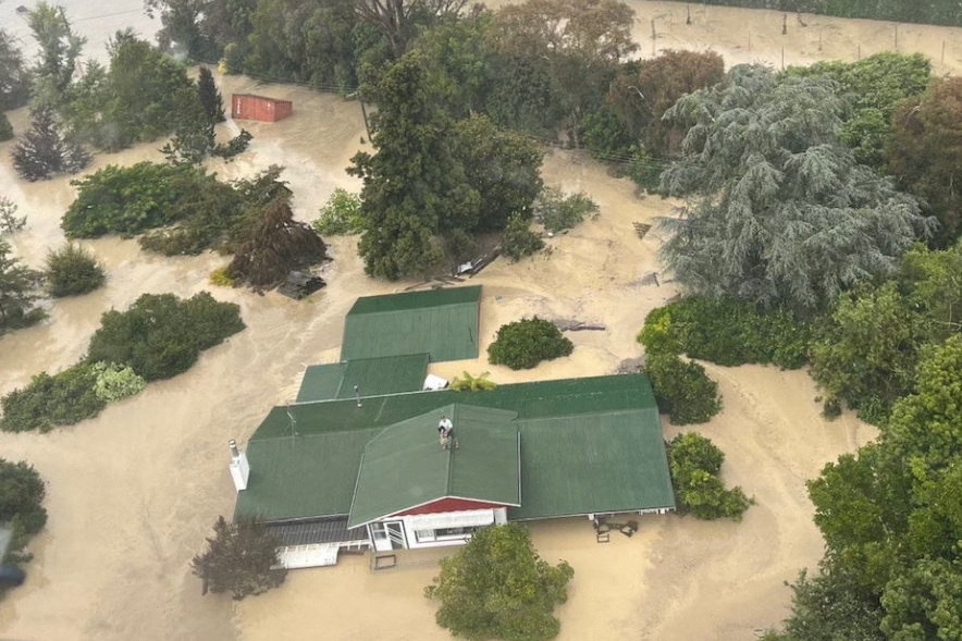 An NH90 helicopter and crew recover people from the rooftops of their homes in Esk Valley, Napier in this handout photo re...