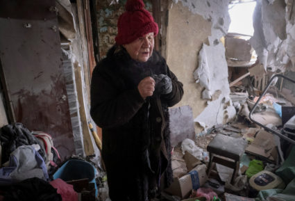 A local resident stands in her house, damaged by a Russian military strike, in the front line city of Vuhledar