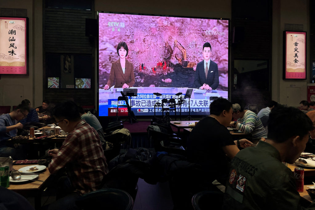 Customers dine in front of a screen displaying a news report on a collapsed coal mine in Alxa League, Inner Mongolia Autonomous Region, at a restaurant in Beijing, China February 24, 2023. Photo by Florence Lo/REUTERS