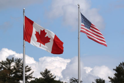 A U.S. and a Canadian flag flutter at the Canada-United States border crossing at the Thousand Islands Bridge in Lansdowne, Ontario, Canada September 28, 2020. Photo by Lars Hagberg/REUTERS