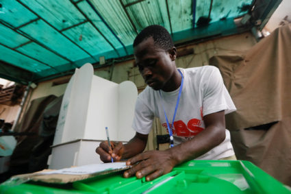 A poll worker writes down a count number during the counting process of Nigeria's presidential election, at a polling unit...
