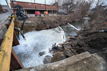 Members of the U.S. Environmental Protection Agency (EPA) inspect the site of a train derailment of hazardous material in ...