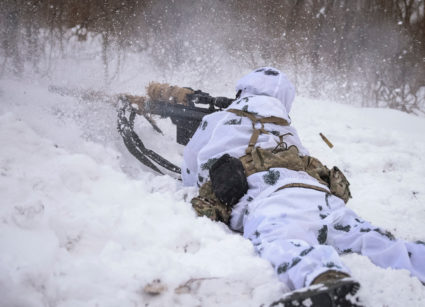 A Ukrainian sniper fires at his position in the front line city of Bakhmut