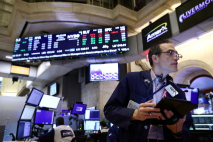 FILE PHOTO: A trader works on the trading floor at the New York Stock Exchange (NYSE) in New York City