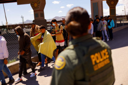 Migrants turn themselves in to U.S. Border Patrol agents after crossing into the United States from Mexico, in El Paso