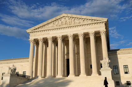A police officer walks in front of the United States Supreme Court Building in Washington, D.C.