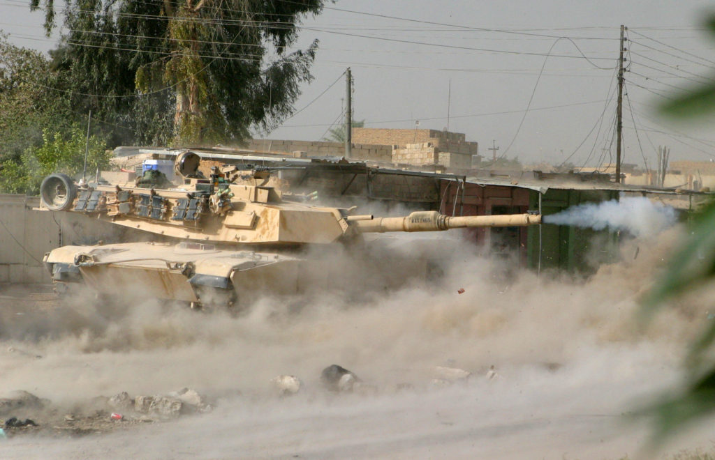 An M1A1 Abrams Tank from 1st Battalion, 8th Marines, fires at a suspected insurgent stronghold in the city of Falluja, 50 km west of Baghdad, in this handout photo released December 8, 2004. Photo by Sgt. Jonathan C. Knauth/HO/USMC/SZH/AA/REUTERS