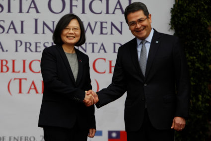 Taiwan's President Tsai Ing-wen shakes hands with her Honduran counterpart Juan Orlando Hernandez during a visit to the Pr...
