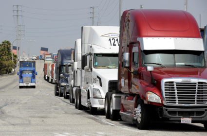 Semi-trucks line up near Pier J to retrieve shipping containers from China-based ship at the Port of Long Beach, in Long Beach, California, U.S., April 4, 2018. Photo by Bob Riha Jr./REUTERS