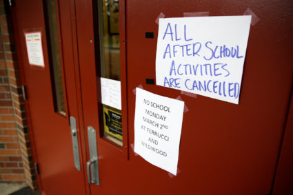 Signs announcing a closure and cancelled activities are pictured at Ferrucci Junior High School after two schools were clo...