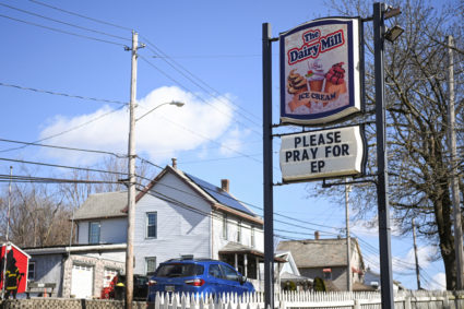 People clean up the site following the derailment of a train carrying hazardous waste in East Palestine, Ohio