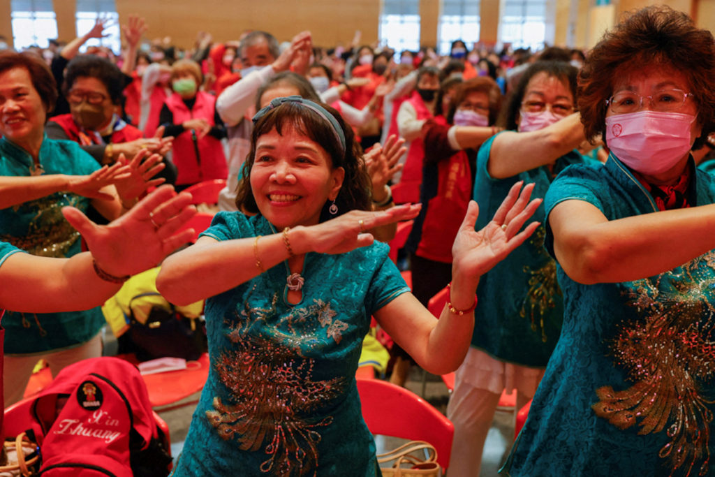 A group of women dance together to celebrate International Women's day in New Taipei City,