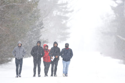 Asylum seekers who stated they were from Turkey walk down Roxham Road to cross into Canada from the U.S. in Champlain, New York, U.S., February 28, 2023. Photo by Christinne Muschi/REUTERS