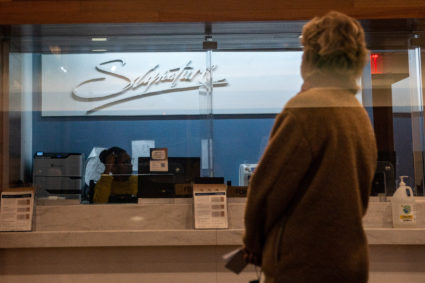 A person waits for a teller at a Signature Bank branch in New York City, U.S., March 13, 2023. Photo by David 'Dee' Delgado/REUTERS