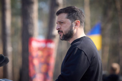 Ukraine's President Volodymyr Zelenskyy sings a national anthem during a commemorative ceremony for Ukrainian servicemen killed in battle for the village of Moshchun, Ukraine March 21, 2023. Photo provided by Ukrainian Presidential Press Service/Handout via REUTERS
