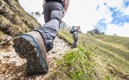 Closeup shot of a hiker's leg on mountain trail