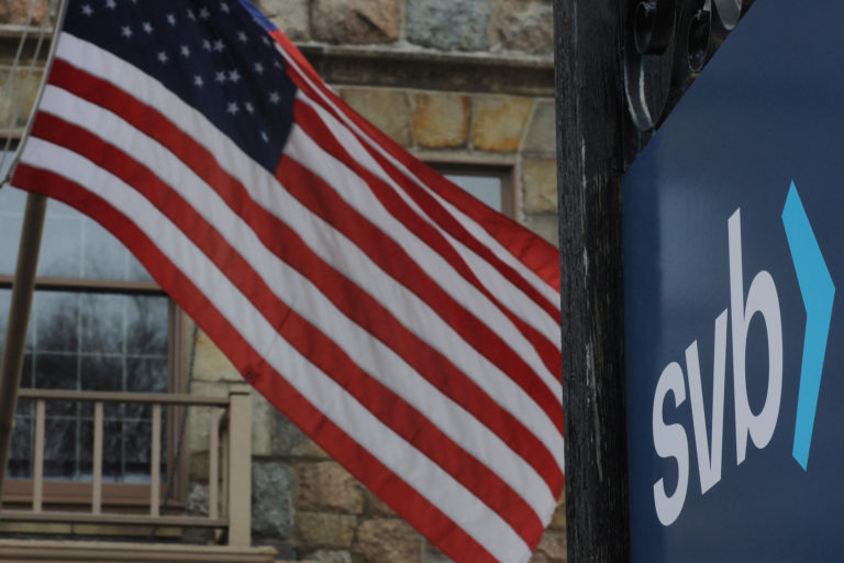 A U.S. flag flies outside a branch of Silicon Valley Bank in Wellesley