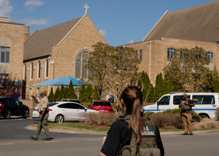 Law enforcement officers and members of the U.S. marshalls work at a family reunification center after a mass shooting at ...