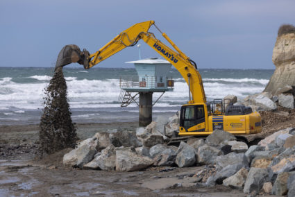 Workers repair beach after winter storms in California
