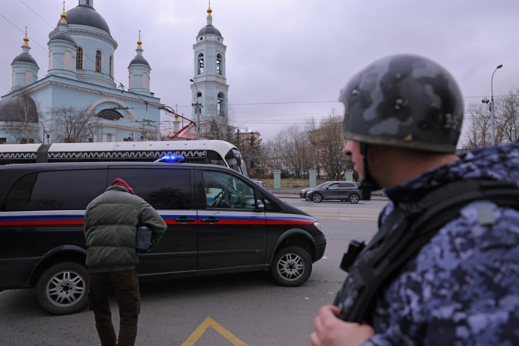 A vehicle carrying The Wall Street Journal reporter Evan Gershkovich, detained on suspicion of espionage, drives away from...