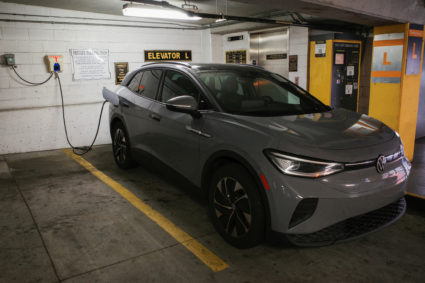 FILE PHOTO: A Volkswagen ID.4 electric vehicle charges at an EV charging station inside a parking garage owned by the City...