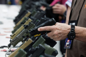 A person tries out a handgun during the National Rifle Association (NRA) annual convention in Indianapolis, Indiana, U.S., April 15, 2023. Photo by Evelyn Hockstein/REUTERS