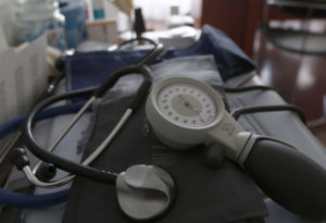 A photo illustration shows a stethoscope and blood-pressure machine as a French general practitioner works in a doctor's o...