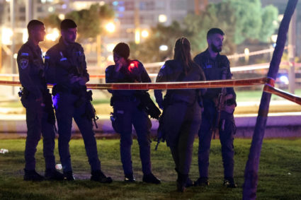 Israeli officials work at the scene of an attack in Tel Aviv