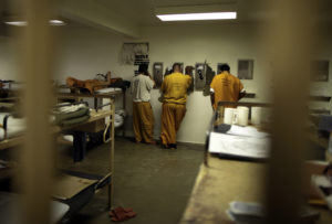 Inmates make phone calls from their cell at the Orange County jail in Santa Ana