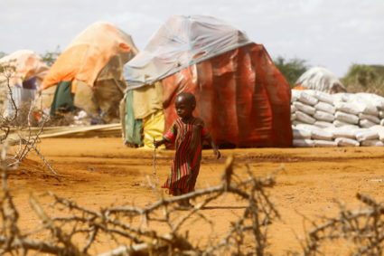 A child walks outside makeshift shelters at the Kaxareey camp for the internally displaced people after they fled from the...