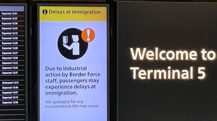 An arrivals board displays a message warning users of terminal 5 about industrial action by Border Force staff, at Heathrow Airport, near London, Britain, December 23, 2022. Photo by Peter Nicholls/REUTERS