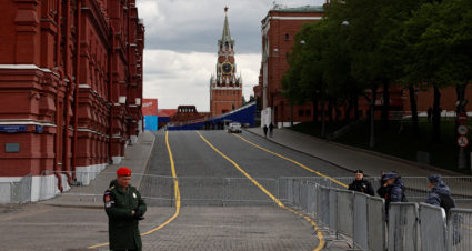 Law enforcement officers stand guard near the closed Red Square on the eve of Victory Day in Moscow
