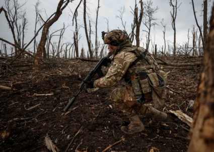 A Ukrainian serviceman checks Russian positions after a fight near the front line city of Bakhmut