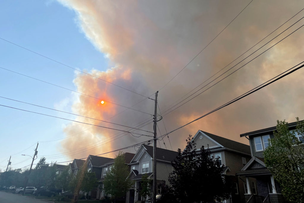 Smoke from the Tantallon wildfire rises over houses in nearby Bedford