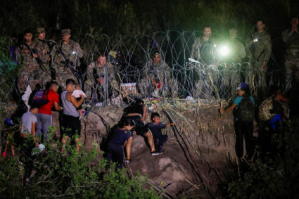 Asylum seekers gather on the banks of the Rio Bravo as Title 42 is lifted, in Matamoros