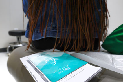A patient listens to instructions on how to take Mifepristone, the first pill in a medication abortion, before she takes t...